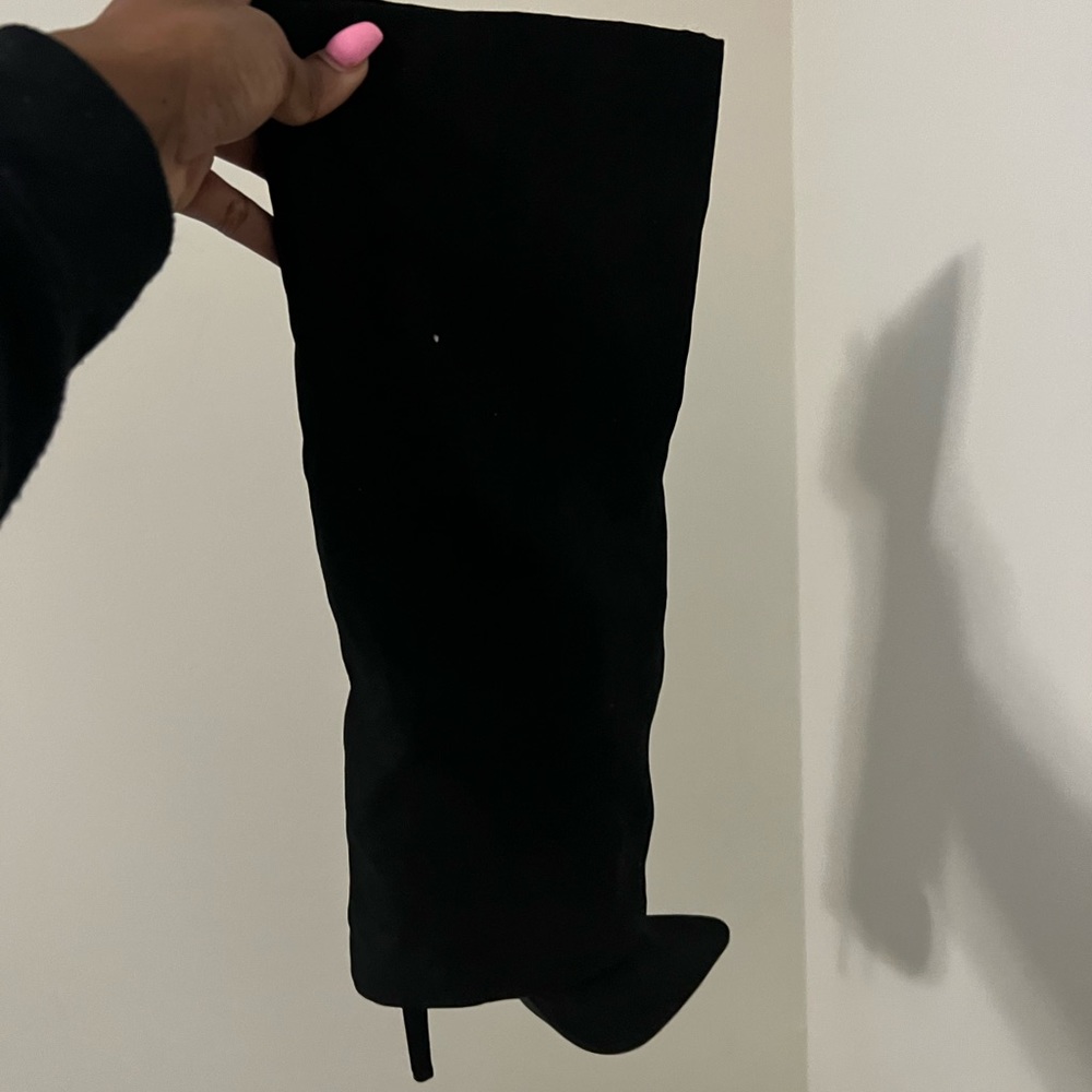Black knee high heeled boots.